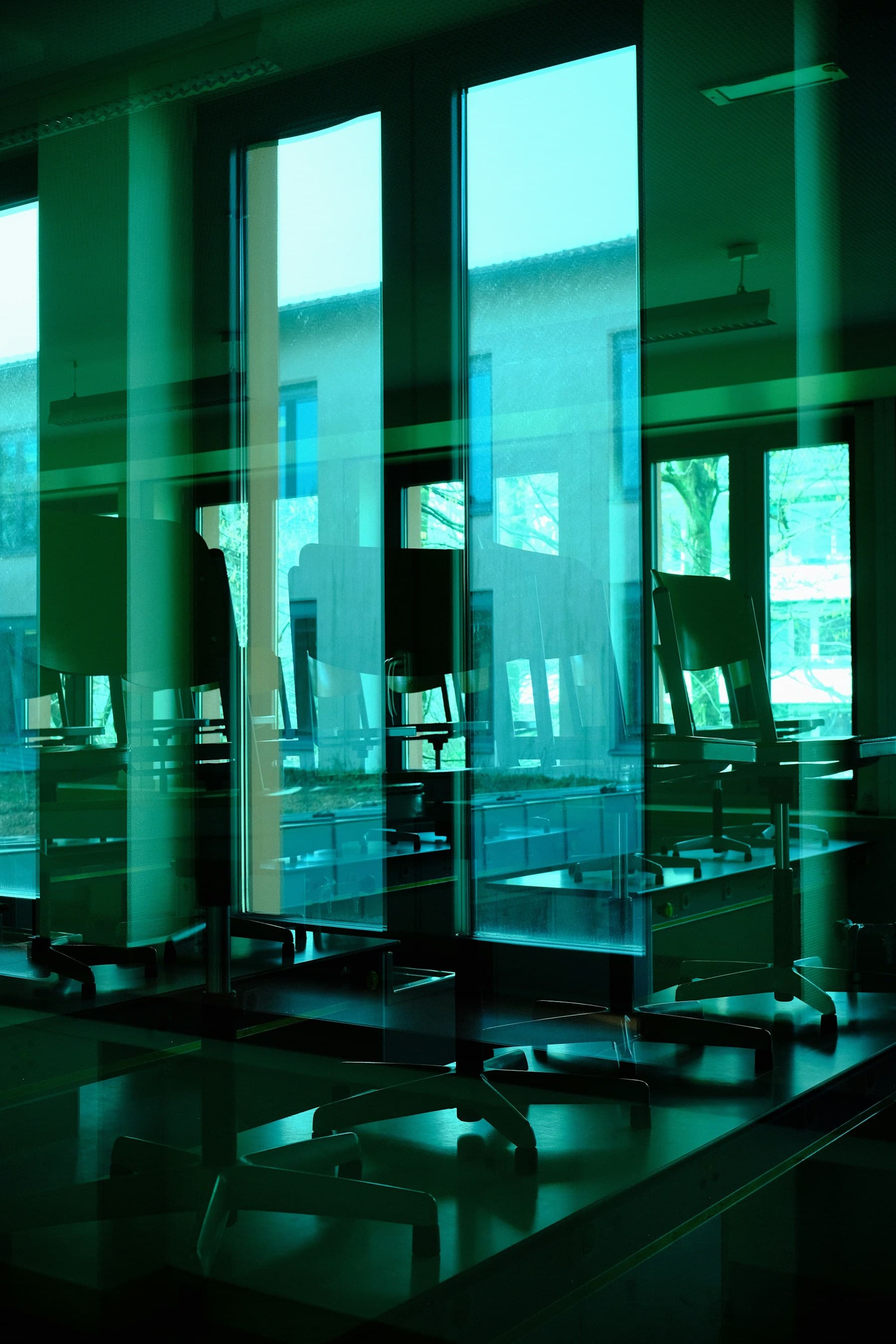 Büroraum mit transparenten Glastrennwänden zwischen den Arbeitsbereichen